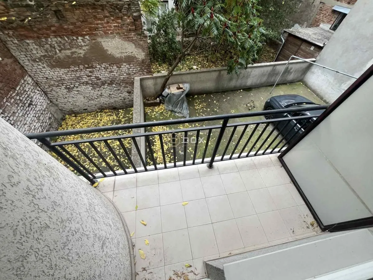 Balcony with a view of the courtyard and surrounding buildings.