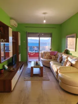 Living room with a sofa set, TV unit, and access to the terrace. - image 2