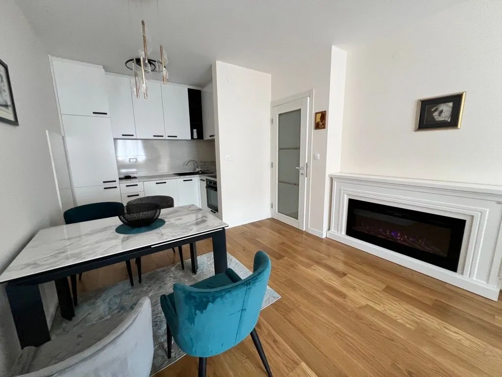 Modern living room with dining area and built-in fireplace.