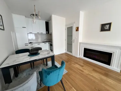 Modern living room with dining area and built-in fireplace. - image 8