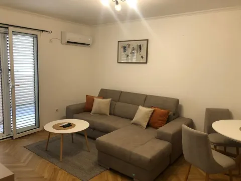 Living room with a sofa, coffee table and access to the terrace. - image 4