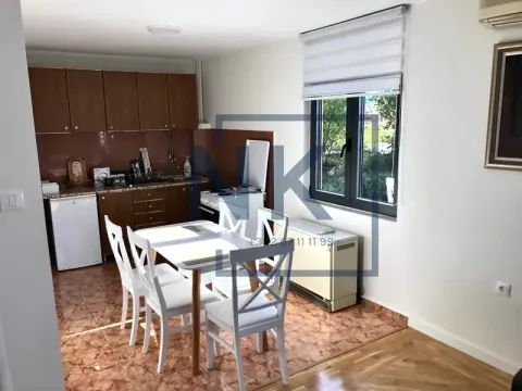 Kitchen with a dining area and wooden cabinets. - image 2