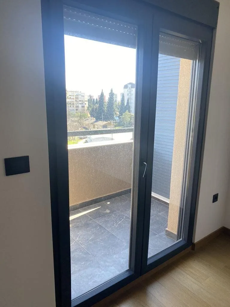 View of the terrace through the balcony door from the room.