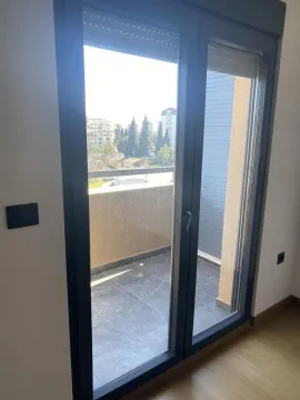 View of the terrace through the balcony door from the room. - image 7