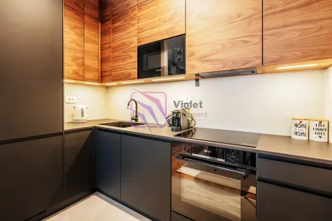 Modern equipped kitchen with dark lower cabinets and wooden wall units. - image 6