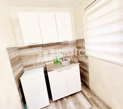 Small kitchen with white cabinets and a sink. - image 3