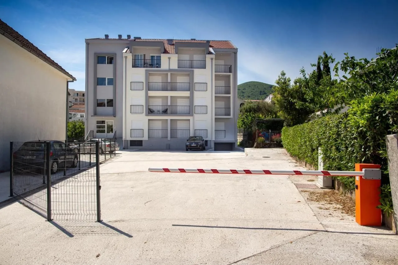 View of the exterior of the building with parking and a ramp.