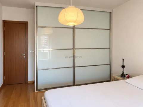 Bedroom with a large built-in wardrobe and a double bed. - image 7