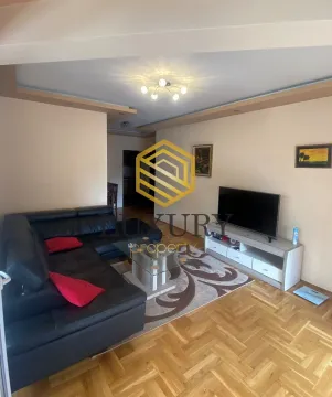 Spacious living room with a sofa and television. - image 2