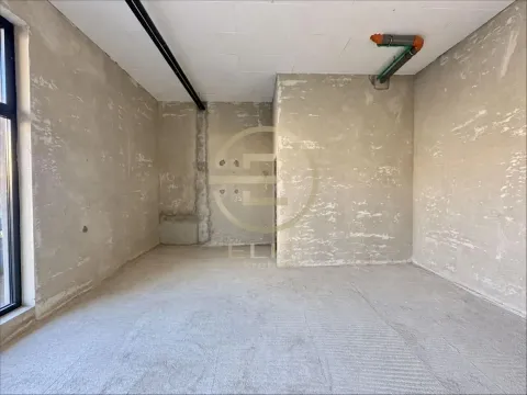Empty room in raw condition with plastered walls and installations. - image 4