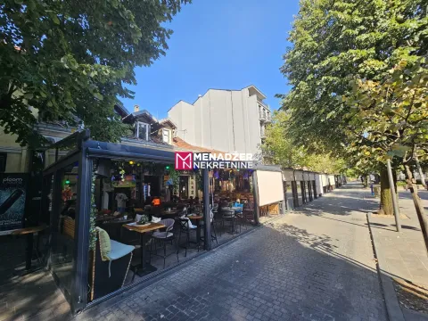 Exterior of a commercial space with a terrace next to a promenade. - image 9