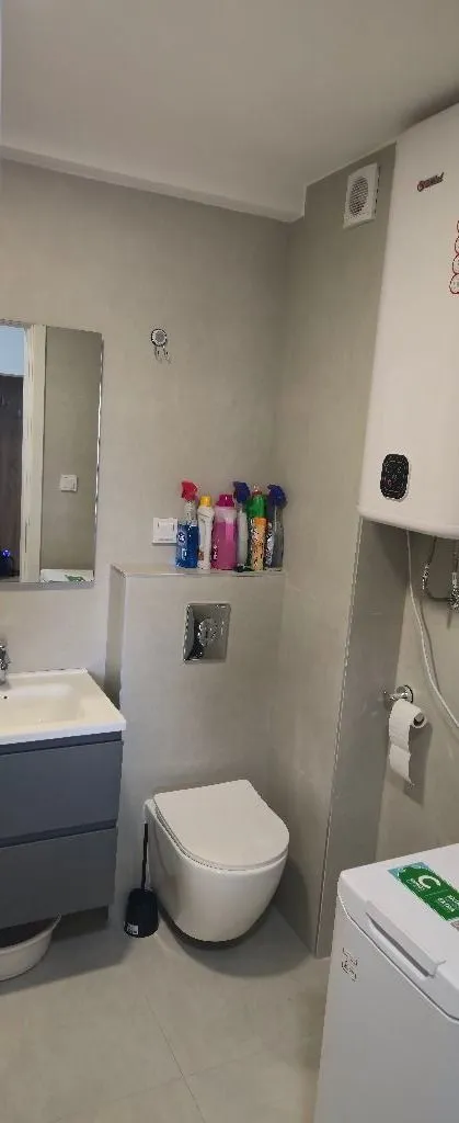 Modernly equipped bathroom with sanitary fixtures and a water heater.