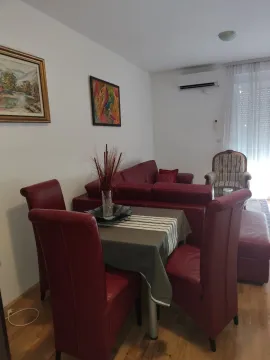 Bright living room featuring a red corner sofa and a dining table. - image 6