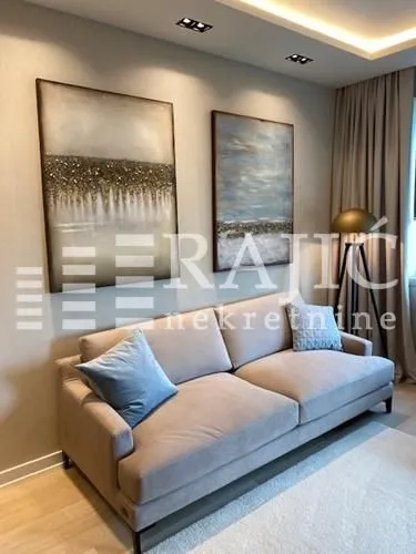 Modern living room with a comfortable sofa and art paintings on the wall.