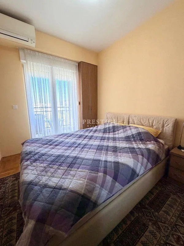 Bedroom with a double bed, wardrobe, and access to the terrace.