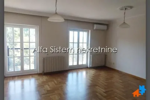 Empty living room with parquet flooring and double doors. - image 2
