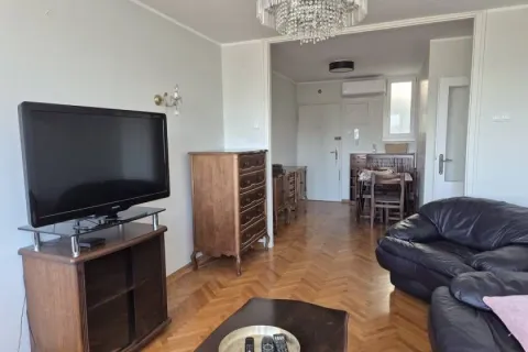 Living room with a sofa set, television, and wooden furniture. - image 11