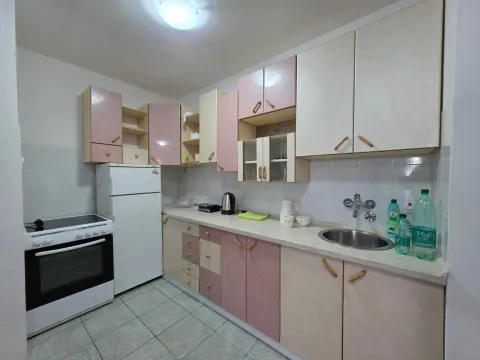 Small kitchen with wood-toned cabinets and white appliances. - image 4