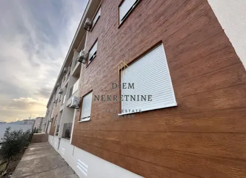 Exterior view of a residential building with a wooden facade and roller blinds. - image 10