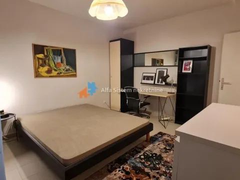 Furnished bedroom with a bed, desk, and wardrobe. - image 21