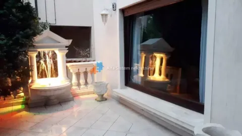 Paved courtyard with a decorative fountain and a large window. - image 22
