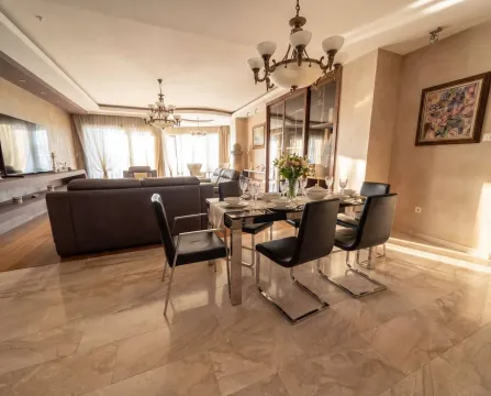 Spacious living room with a dining area and seating set. - image 4