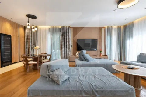Spacious living room with a sofa set, dining area, and wooden wall panels. - image 23