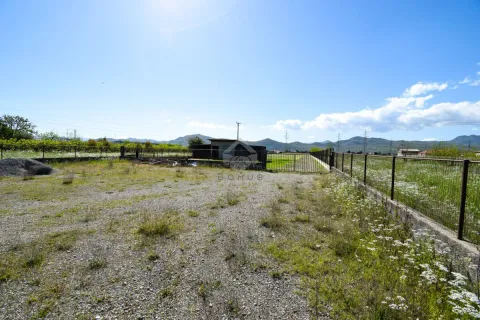 View of a fenced plot with grassy area and hills in the background. - image 6