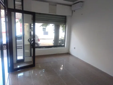 Empty commercial space with glass entrance doors and tiled flooring. - image 3