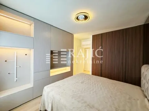 Modern bedroom with built-in wardrobes and a double bed. - image 6