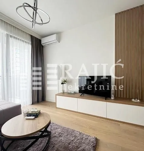 Modern and bright living room with TV console and wooden wall panels.
