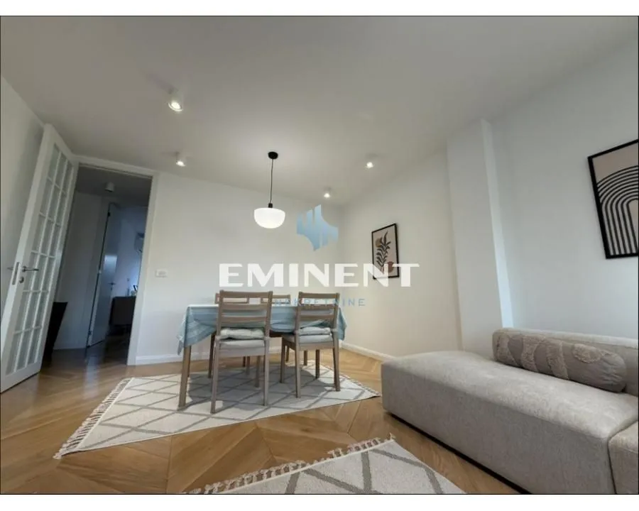 Living room with a dining area and a sofa.
