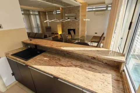 View from the kitchen with a breakfast bar towards the dining and living area. - image 8
