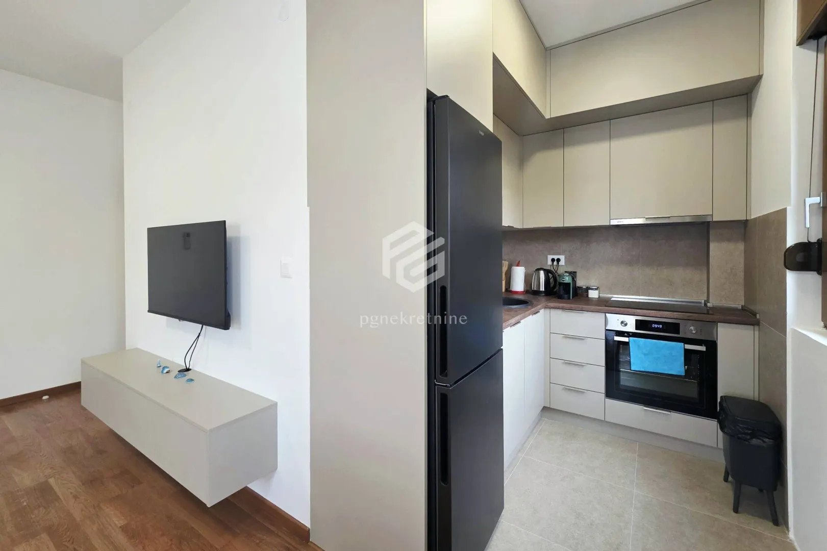 Compact kitchen with built-in appliances and cabinetry.