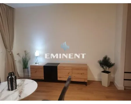 Living room with a chest of drawers, dining table and decorative lighting. - image 10