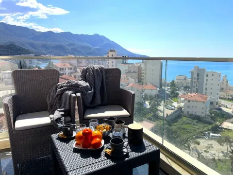 Furnished balcony with seating set and view of the sea and the city. - image 11