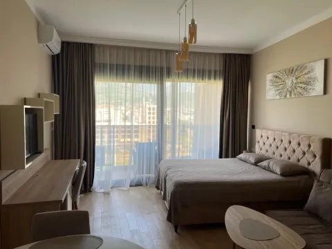 Spacious bedroom with a double bed, desk, and access to the terrace. - image 5