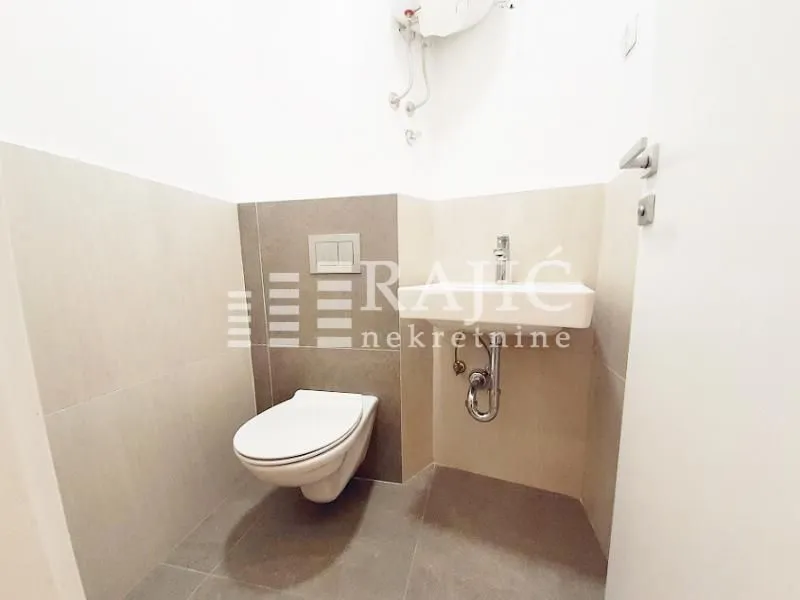 Small bathroom with toilet and sink.
