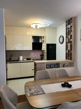 Modern kitchen with built-in appliances and an extension featuring a dining table. - image 6
