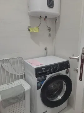 Small bathroom with a washing machine and boiler. - image 11