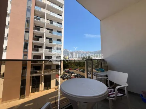 Covered balcony with seating furniture and a view of the building and surroundings. - image 3