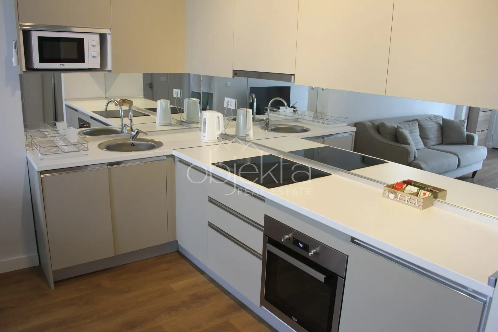 Modern kitchen with built-in oven, cooktop, and sink.