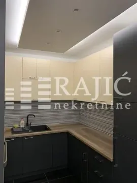 Small kitchen with dark cabinets and recessed lighting. - image 5