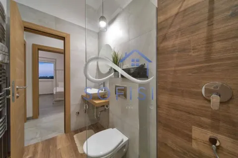 Modernly equipped bathroom with a shower cabin and wooden details. - image 19