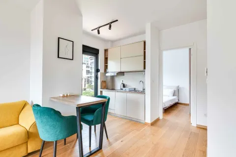 Small kitchen with a dining table and a view of the living room. - image 5