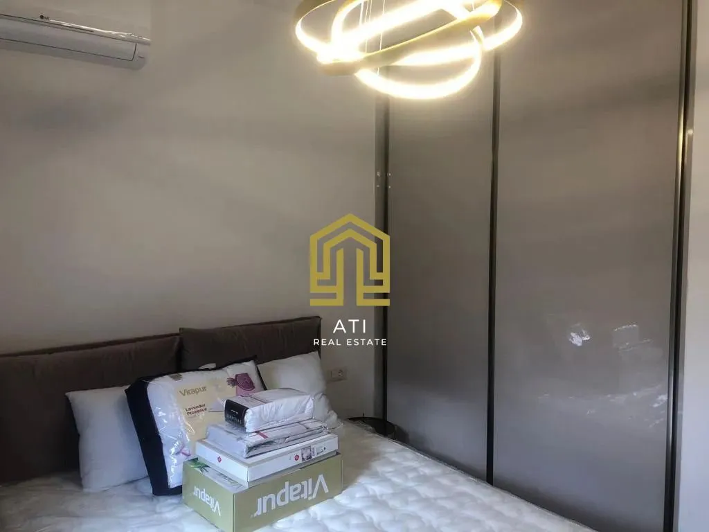 Bedroom with a double bed, wardrobe, and modern chandelier.