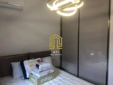 Bedroom with a double bed, wardrobe, and modern chandelier. - image 16