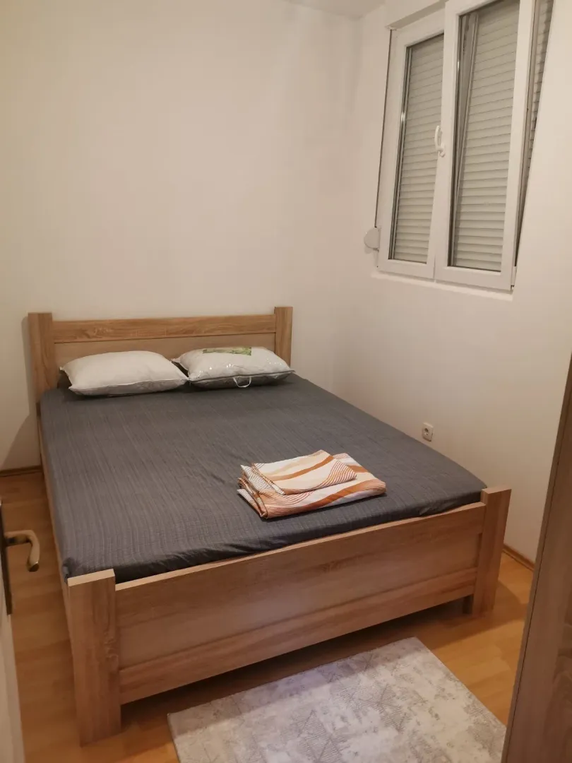 Simple bedroom with a wooden bed.