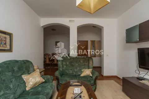 Living room with green sofas and a television. - image 2