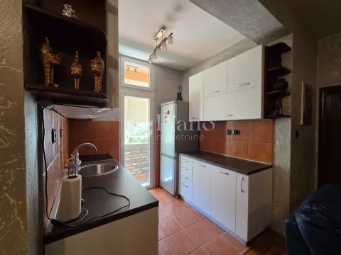 Kitchen equipped with white cabinets, a refrigerator, and a countertop. - image 4